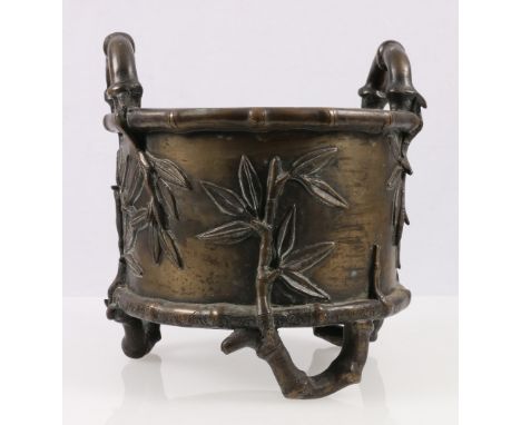 Heavy Chinese bronze jardiniere of circular section with faux bamboo triple supports and loop handles, relief leaf decoration