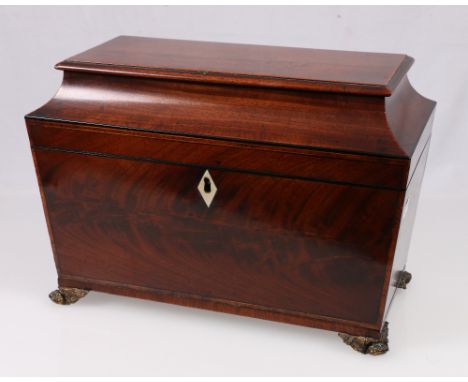 Regency flame mahogany sarcophagus tea caddy, the interior with fitted canisters, raised on gilt paw feet, 22cm x 31.5cm.
