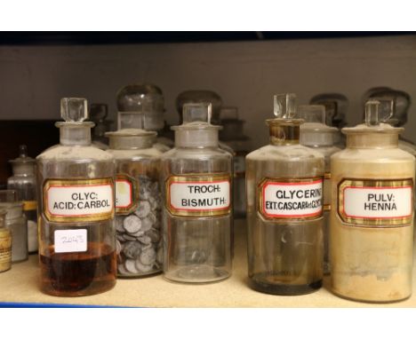 A set of twenty six pharmacy jars, with gilt and white labels, various stoppers, together with three gilt labelled jars and f