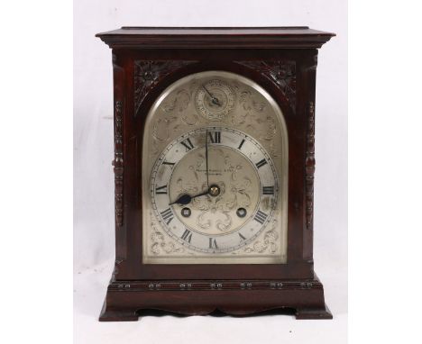 A Fenton Russel carved mahogany mantle clock, with silvered Roman dial, striking on a coiled gong, 29cm