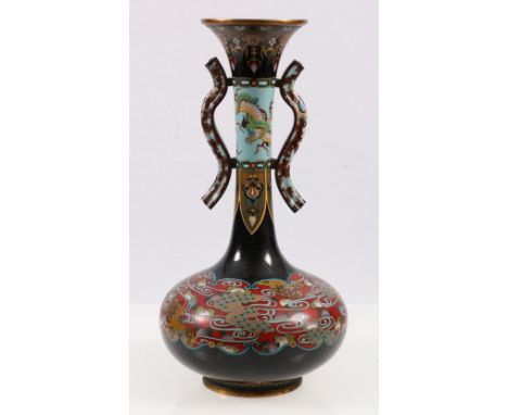 Cloisonne bottle vase with flaring rim and scroll handles to the elongated neck decorated with dragons and waves, on a red an