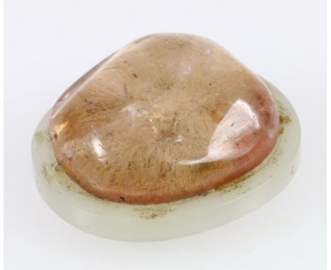 Chinese 19th century jade belt buckle of oval shape, set with an irregular oval cabochon rock crystal, 6cm x 5cm. CONDITION R