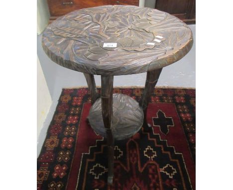 Eastern stained and carved circular occasional table, with foliate decoration and under shelf. 50cm diameter approx. (B.P. 21