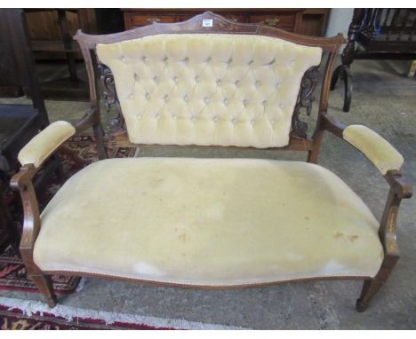 Late Victorian rosewood inlaid parlour sofa, the shaped top above a carved and upholstered button back, with shaped open padd