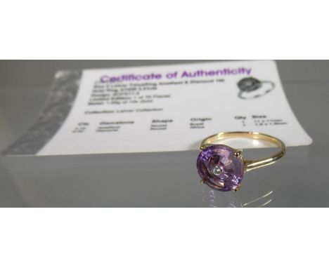 9ct gold amethyst dress ring, the fancy cut amethyst set to the centre with a diamnd. Stamped 10K.  Ring size S.  Approx weig