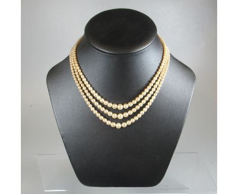 Three strand simulated pearl necklace.(B.P. 21% + VAT) 