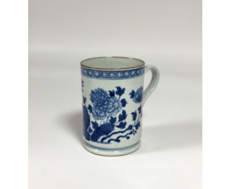 A Kangxi blue and white porcelain tankard, late 18th century, of cylindrical form, decorated with blossoming boughs, unmarked