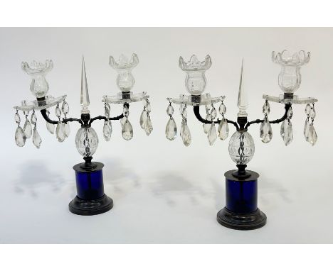 A pair of twin-light cut and moulded glass table lustres in Regency style, early 20th century, each with "Bristol" blue glass