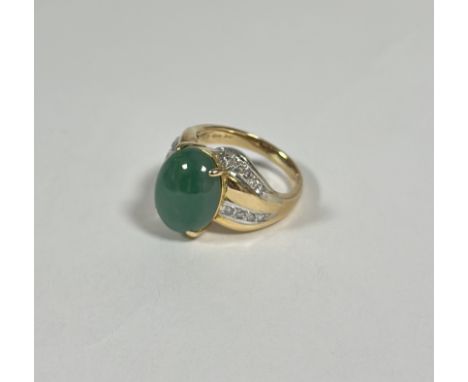 A jade and diamond dress ring, the oval jade cabochon claw-set between crossover shoulders each set with twin lines of round 