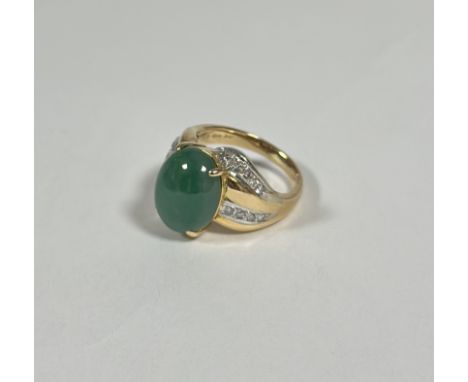 A jade and diamond dress ring, the oval jade cabochon claw-set between crossover shoulders each set with twin lines of round 