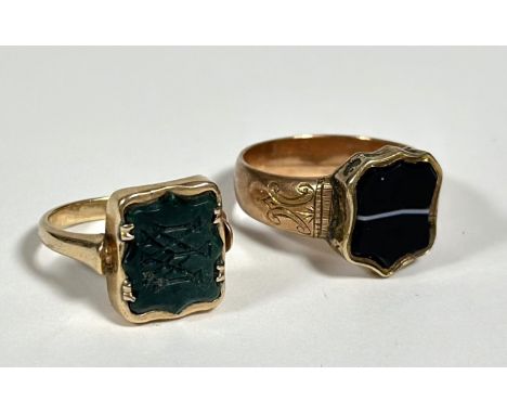 Two late 19th century hardstone-mounted signet rings: the first with a shield-shaped panel of banded agate; the second a bloo