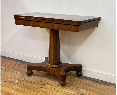 A William IV rosewood card table, the revolving top opening to reveal a baize lined playing surface, over a tapered octagonal