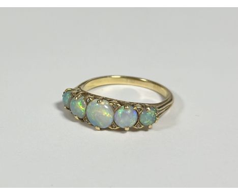 A five-stone opal ring, late 19th century, the oval-cut graduated stones spaced by eight old-cut diamond points, on a yellow 