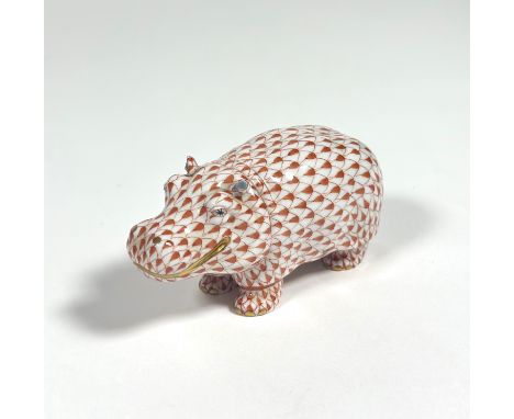 A Herend porcelain model of a smiling hippopotamus, in coral, printed mark. Length 11.5cm