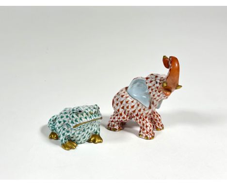 Two Herend porcelain models of animals comprising: an elephant with upraised trunk in coral and a seated frog in green, each 