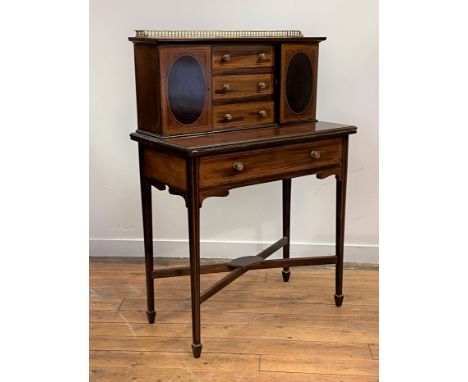 An Edwardian mahogany bonheur de jour, the superstructure with brass gallery, boxwood stringing, and satinwood cross bands, t