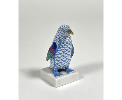 A Herend porcelain model of a penguin, in the blue scale pattern, modelled on a square base, printed mark. Height 11cm