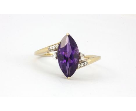 A 9ct yellow gold ring set with a large marquise cut amethyst and diamonds, (S).