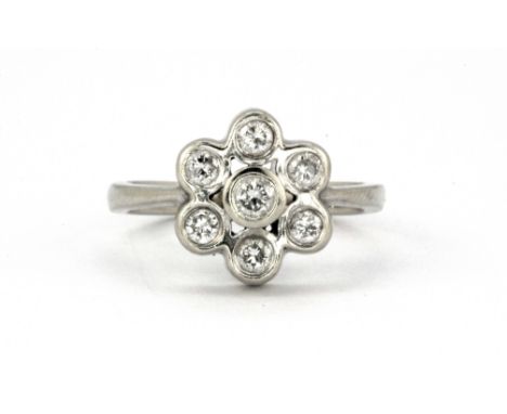 A 14ct white gold (stamped 14ct) diamond set flower shaped cluster ring, (N).