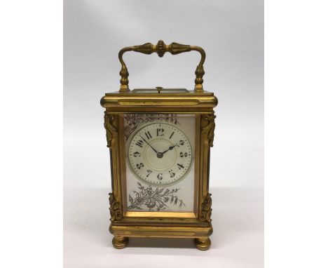 A fine early 20thC gilt brass French carriage clock with silvered mother of pearl dial and button repeat movement. H.19cms. U
