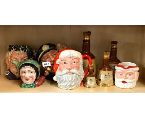 Three large Royal Doulton character jugs, a Beswick teapot, a Father Christmas jug and Wade whiskey bells.