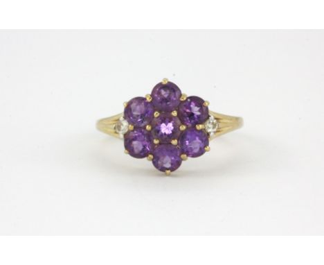 A 9ct yellow gold amethyst set cluster ring with diamond set shoulders, (N).