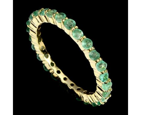 A 925 silver gilt full eternity ring set with emeralds, (P.5).
