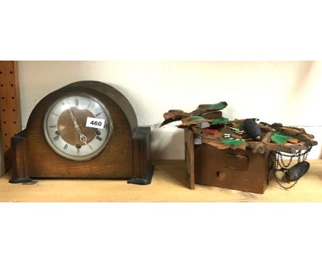 An oak mantle clock and a wooden cuckoo clock.