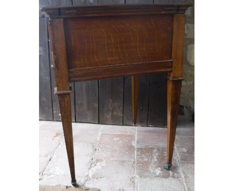 A circa 1900 oak tea or decanter table with double rising top and rising interior, raised on square tapered legs to brass cap