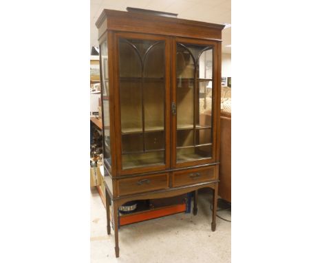An Edwardian mahogany inlaid and glazed display cabinet above two short drawers on square tapering legs to spade feet, togeth