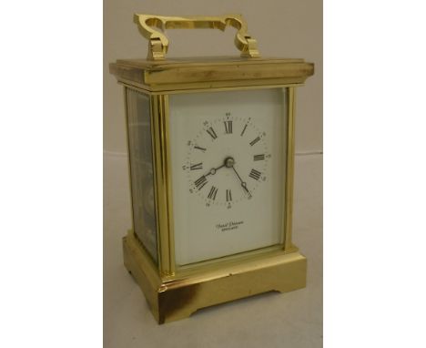 A brass cased carriage clock, the dial with Roman and Arabic numerals inscribed "David Peterson England"