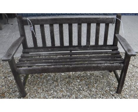 A modern stained teak garden bench