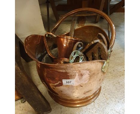 A collection of various copper ware to include helmet shaped coal scuttle, saucepan, ale muller, saucepan lids, together with