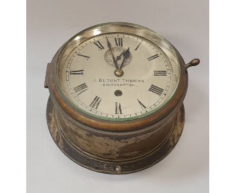 A brass cased ship's clock by J Blount Thomas of Southampton, the silvered dial with Roman numerals enclosing a subsidiary se