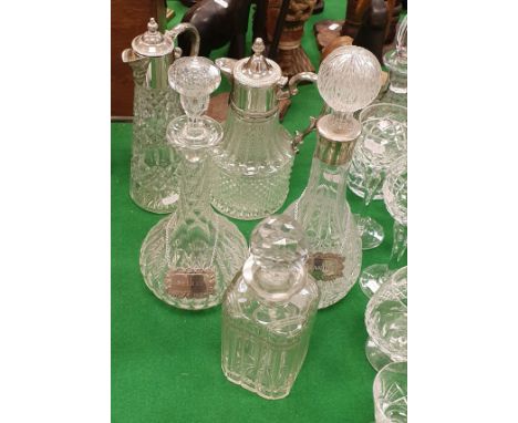 Two claret jugs with white metal mounts and three various decanters two with bottle tags "Sherry" and "Brandy"