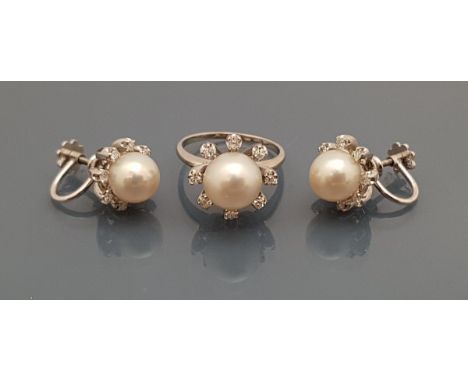 A 14ct white gold cultured pearl and diamond set ring, the central pearl surrounded by eight single diamonds in a Modernist s