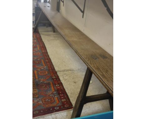 An 18th Century oak bench of plain form