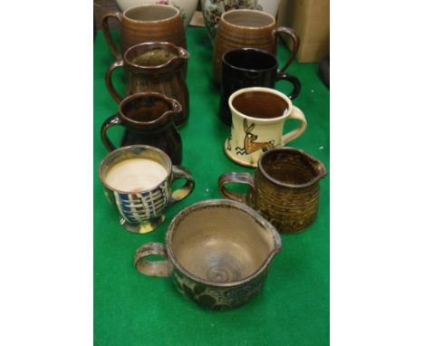 A collection of various studio pottery including two Poole Sylvan ware M70 mugs, a Ewany Pottery mug dated 1950-71, a St. Ive