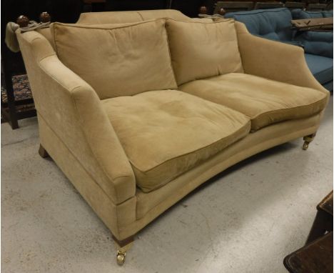 A modern fawn upholstered Knole style sofa, with swept arms and concave front rail, raised on square tapered legs to castors