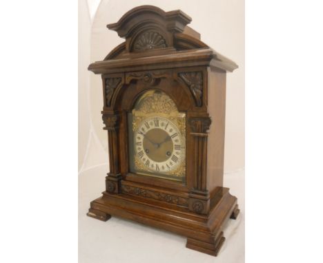 A late 19th Century walnut cased mantel clock, the eight day movement by Junghans, the silvered chapter ring with Roman numer