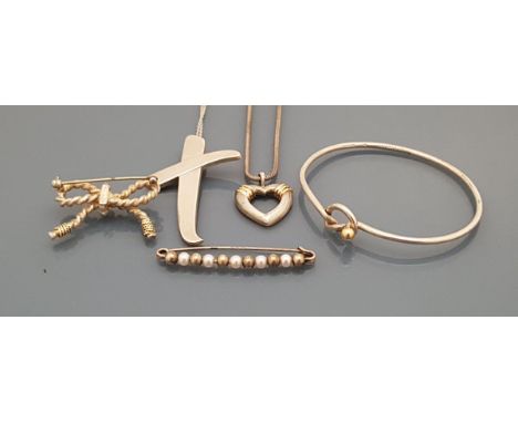 A collection of silver Tiffany jewellery comprising bangle, Paloma Picasso cross pendant, love heart necklace, bow brooch and