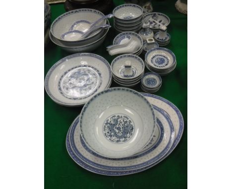 A collection of various modern Chinese blue and white "rice" pattern dinner wares including various serving and eating bowls,