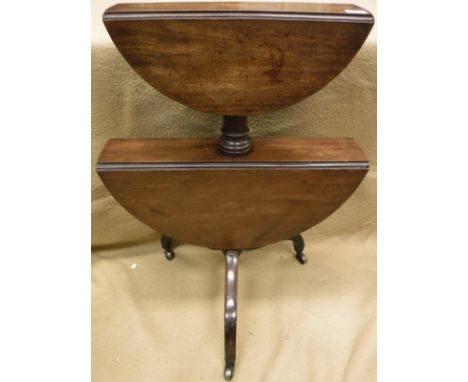 A Regency mahogany dumb waiter with drop leaves, raised on a tripod base