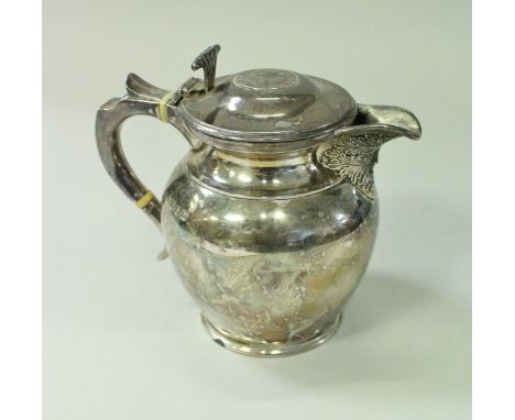 A George V silver hot water jug of small proportions, the lid with Queen Anne silver coin over a plain body with Green Man em