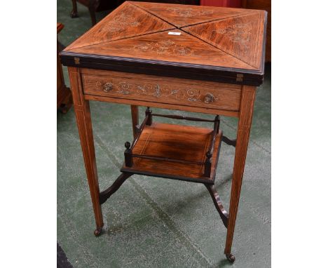 An Edwardian rosewood and marquetry envelope card table, the hinged covers enclosing a baize lined playing surface and counte