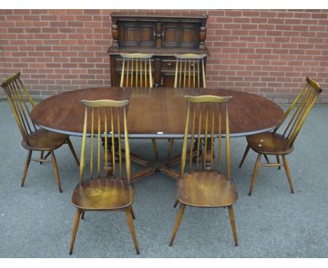 An Ercol extending dining table and chairs; an oak buffet sideboard 