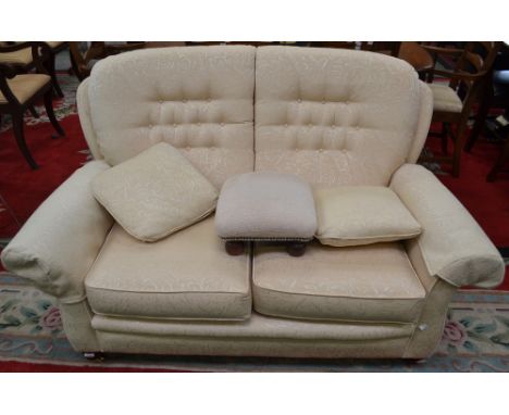 A two seat sofa, cream brocade upholstery; a similar footstool (2)