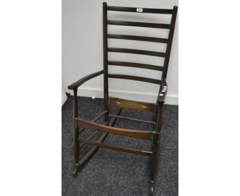 An Ercol style dark mahogany rocking armchair