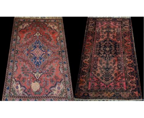 A Middle Eastern rectangular woven wool carpet, in tones of red, pink and blue with geometric motifs, probably Caucasus; anot