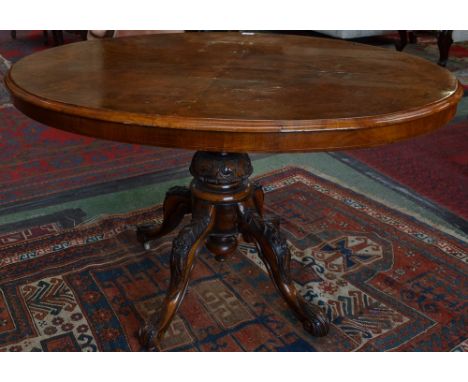 A Victorian burr walnut oval breakfast table, moulded quarter veneered top, turned pillar and cabriole legs carved with acant